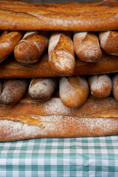Baguettes stacked together on market stall, close-up